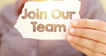 Person holding sign stating Join Our eam