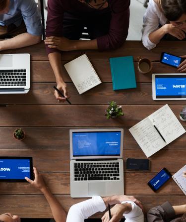 overhead view of people working on laptops