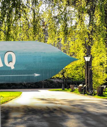 FAQ sign in a park setting