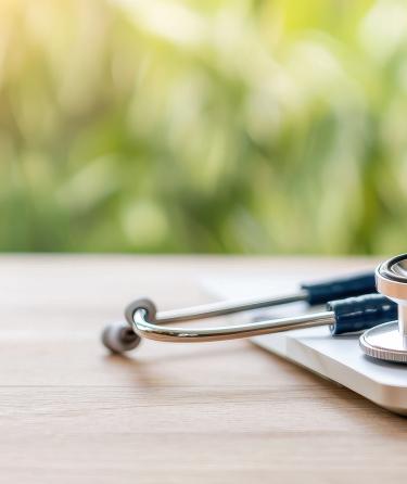 stethoscope on top of laptop on surface