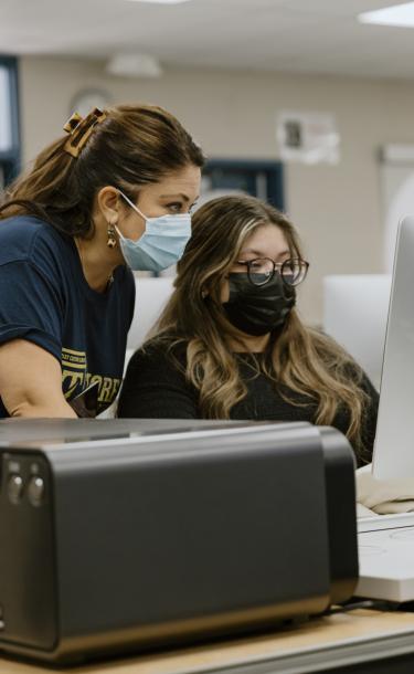 Teacher Helping a Student Girl