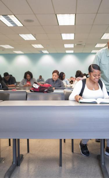 Professor with Students Explaining at Class