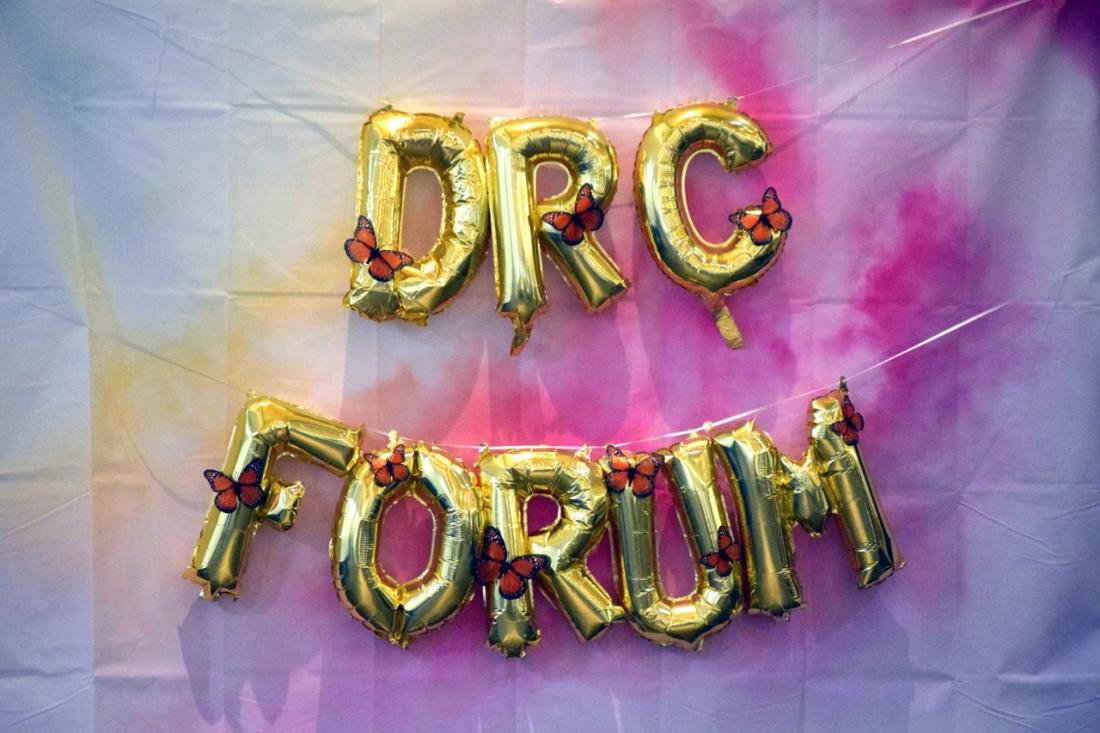  Inflatable gold balloons the spell out “DRC Forum” with paper butterfly decorations