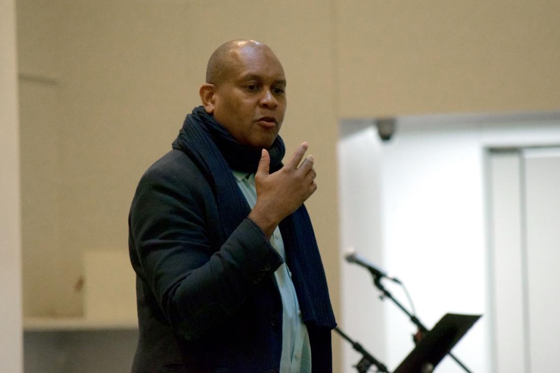 Kevin Powell speaking at a podium at Los Angeles Mission College for Black History Month