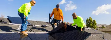 Team of workers install rooftop solar in California.