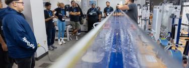  Josephy Lucey, assistant professor with the Department of Civil Engineering, performs a hydraulics and water demonstration for members of the STEM Core Engineering Degree Apprenticeship Pathway